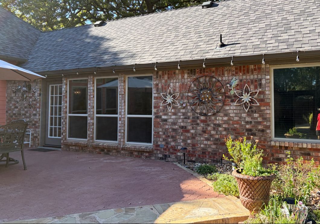 Same brick home after window tint, windows now private