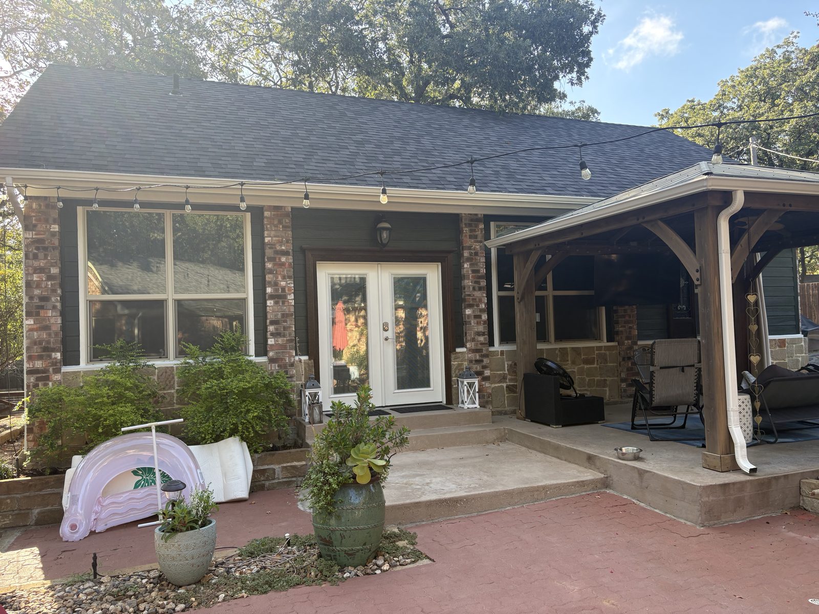 Covered patio with tinted windows and doors
