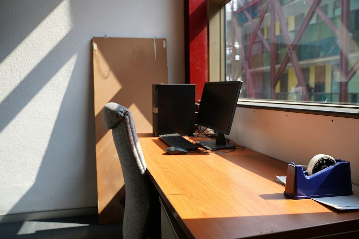 Office desk with monitors in direct sun